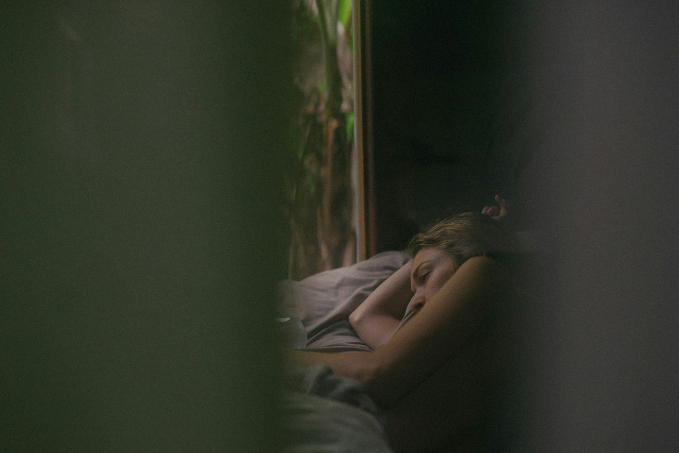 A person sleeping in a dimly lit room
